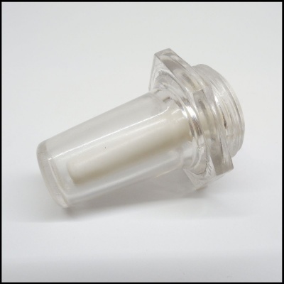 Peça cilíndrica transparente com interior branco e base hexagonal