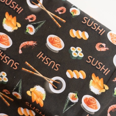 Tecido preto com padrão de comida japonesa e texto SUSHI