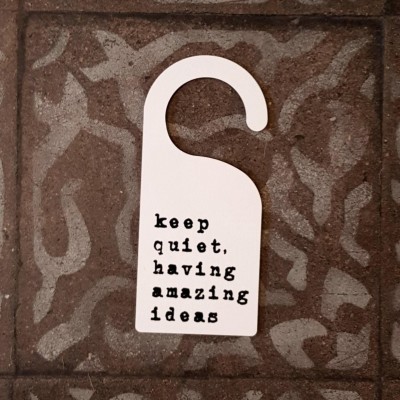 Door hanger 'keep quiet, having amazing ideas'