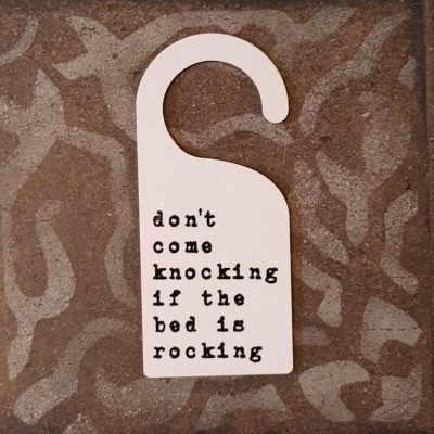 Door hanger 'don't come knocking if the bed is rocking'
