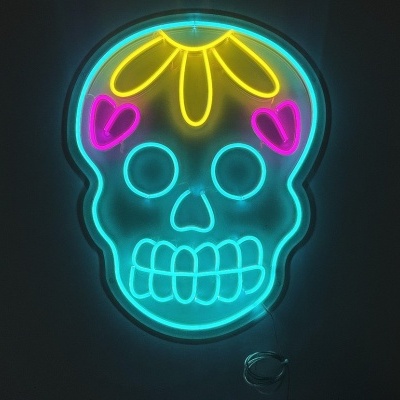 Letreiro em néon colorido em forma de caveira sobre fundo preto