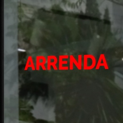 Placa vermelha com texto ARRENDA numa porta de vidro