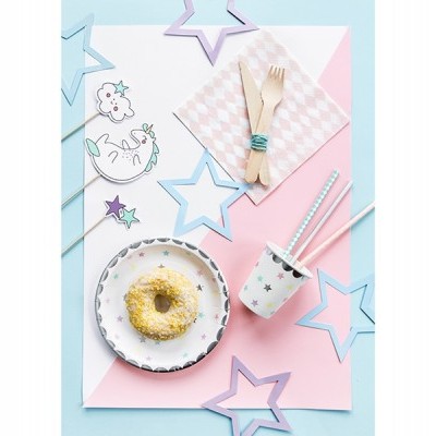 Mesa decorada com prato de donut, copo de papel com canudos, guardanapo rosa, talheres de madeira e estrelas de papel