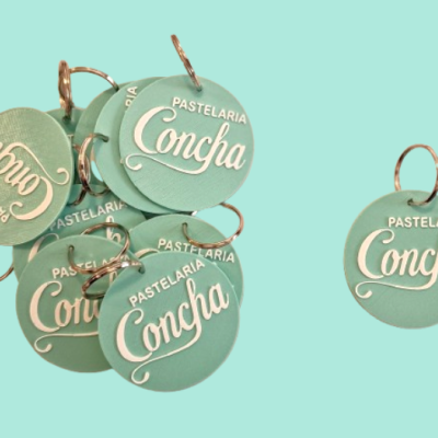 Porta-chaves redondos verde claro com texto branco PASTELARIA Concha