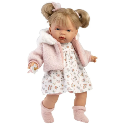 Boneca de bebé com casaco rosa, vestido floral e chupeta.