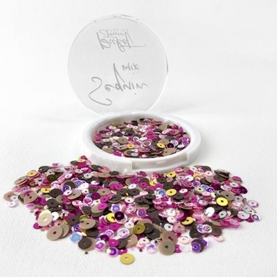 Frasco aberto com lantejoulas coloridas espalhadas