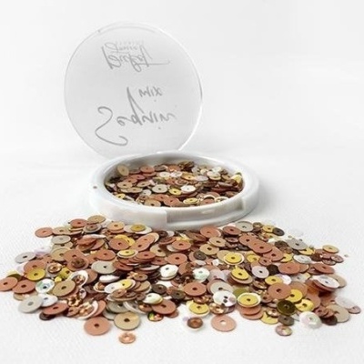 Sequins metálicos dourados, bronze e prata em recipiente branco aberto com tampa escrita 'MIX'