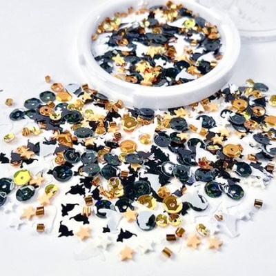 Confetes decorativos em tons preto, dourado e branco com estrelas e círculos