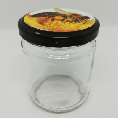 Pote de vidro transparente com tampa preta decorada com girassol