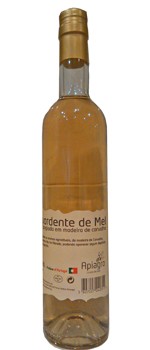 Garrafa de destilado de mel com rótulo branco e tampa dourada