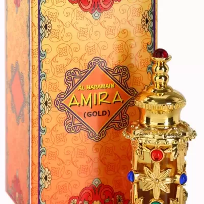 Frasco dourado de perfume com pedras coloridas ao lado de uma caixa laranja decorada com o texto AL HARAMAIN AMIRA (GOLD)