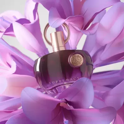 Frasco de perfume roxo entre pétalas de flor lilás