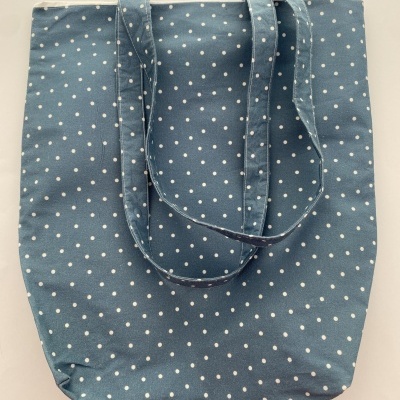 Saco de tecido azul com bolas brancas