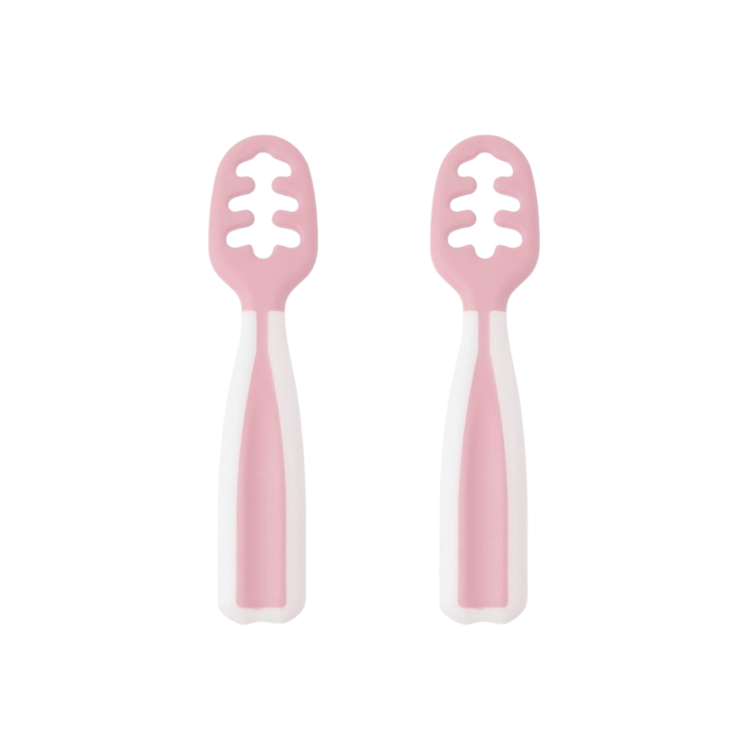 Utensílios de cozinha rosa e branco com cabos largos e áreas vazadas.