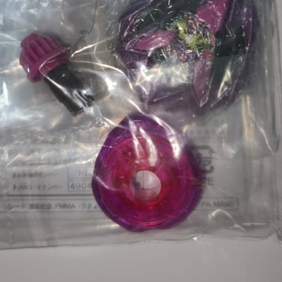 Three purple and black plastic components in a clear bag with text