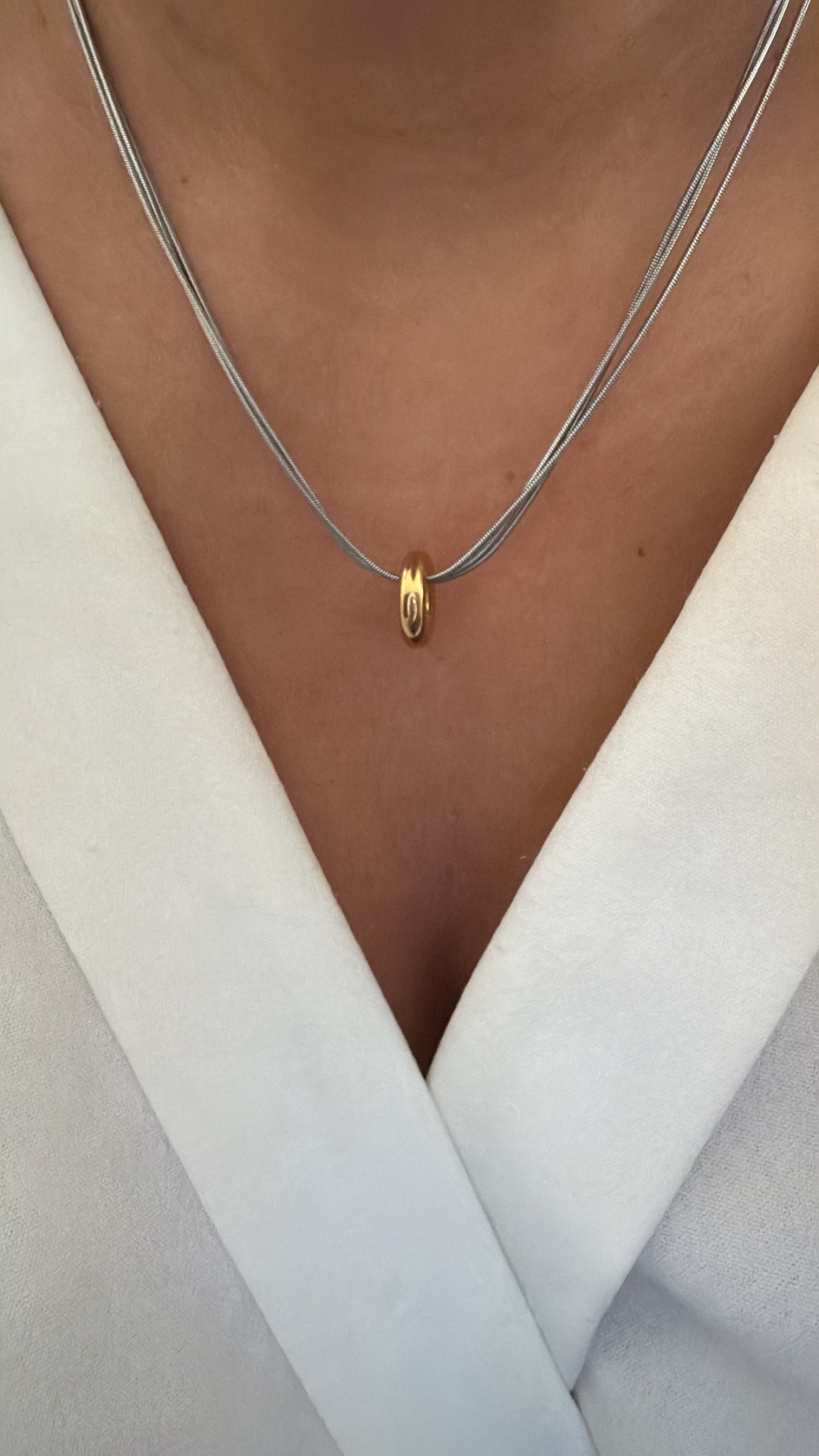 Colar com pingente anel dourado em corrente prateada dupla no pescoço