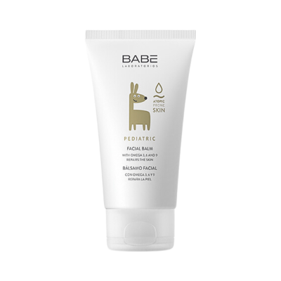 Creme facial bebé em tubo branco com ilustração dourada e texto em inglês e espanhol.