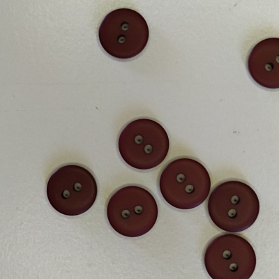 Oito botões castanho avermelhado com dois furos sobre superfície branca