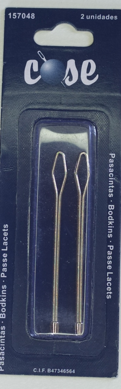 Embalagem de passacintas metálicas douradas com fundo azul escuro e texto em várias línguas