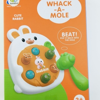 Brinquedo WHACK-A-MOLE Cute Rabbit em embalagem laranja com detalhes verdes, para crianças 3+ anos.