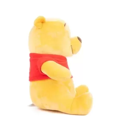 Ursinho de peluche amarelo com camisola vermelha de perfil