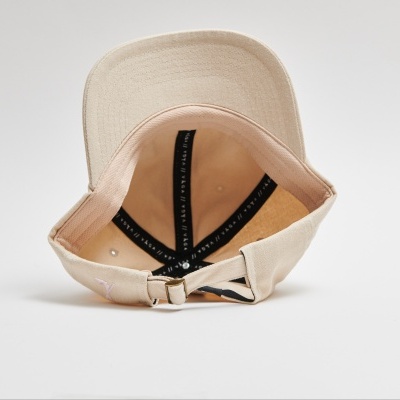 Boné bege visto por dentro com tiras pretas e fecho ajustável.