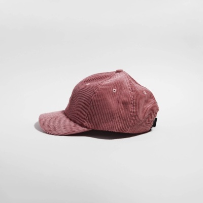 Boné rosa de veludo cotelê sobre fundo branco