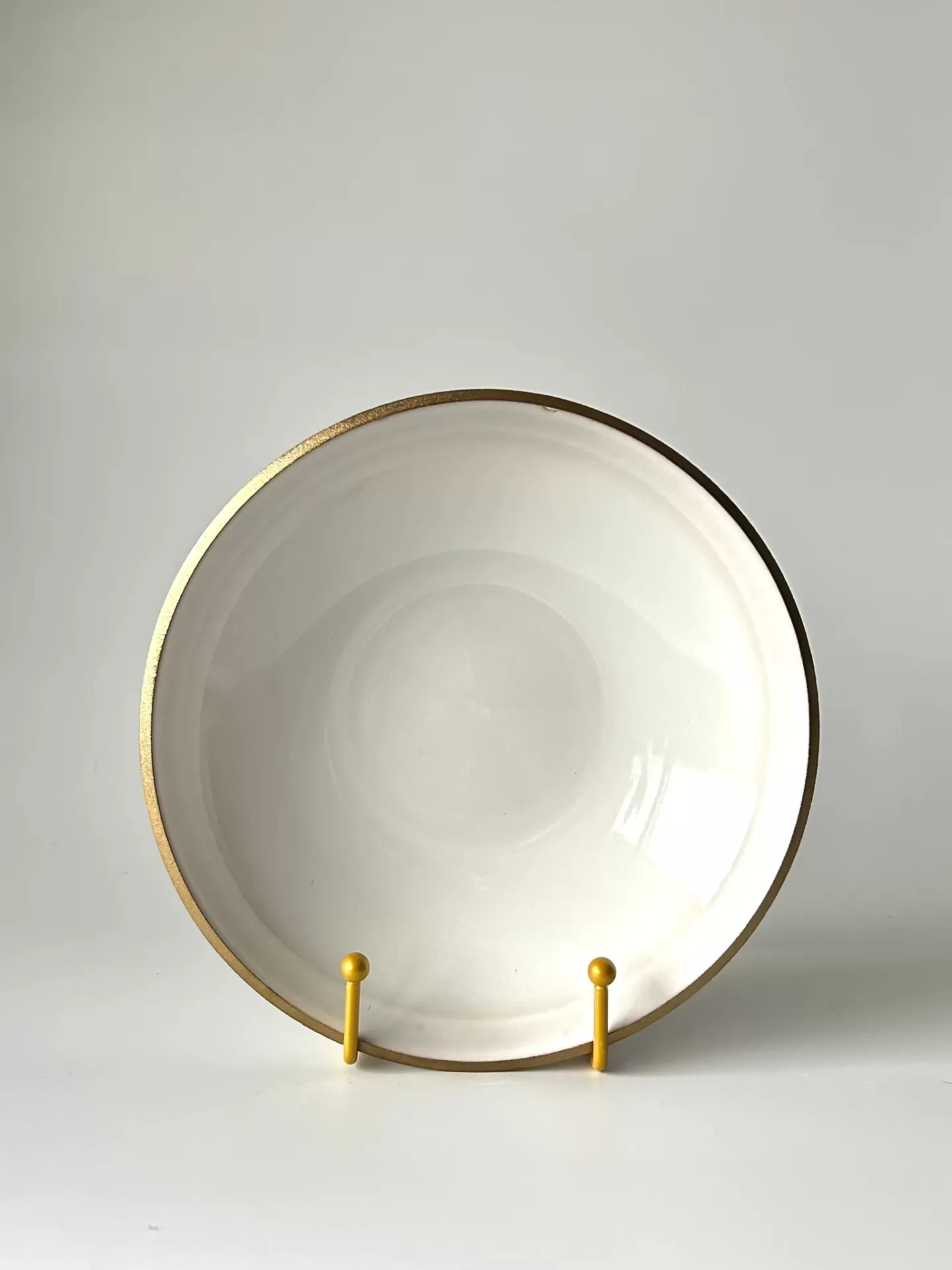 Prato branco com borda dourada numa base amarela