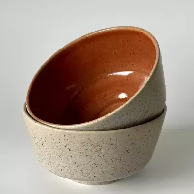 Pratos de cerâmica cinza com interior laranja empilhados