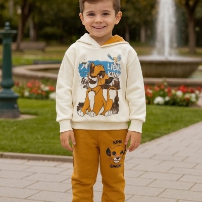 Menino em parque com conjunto de roupa LION KING creme e camel