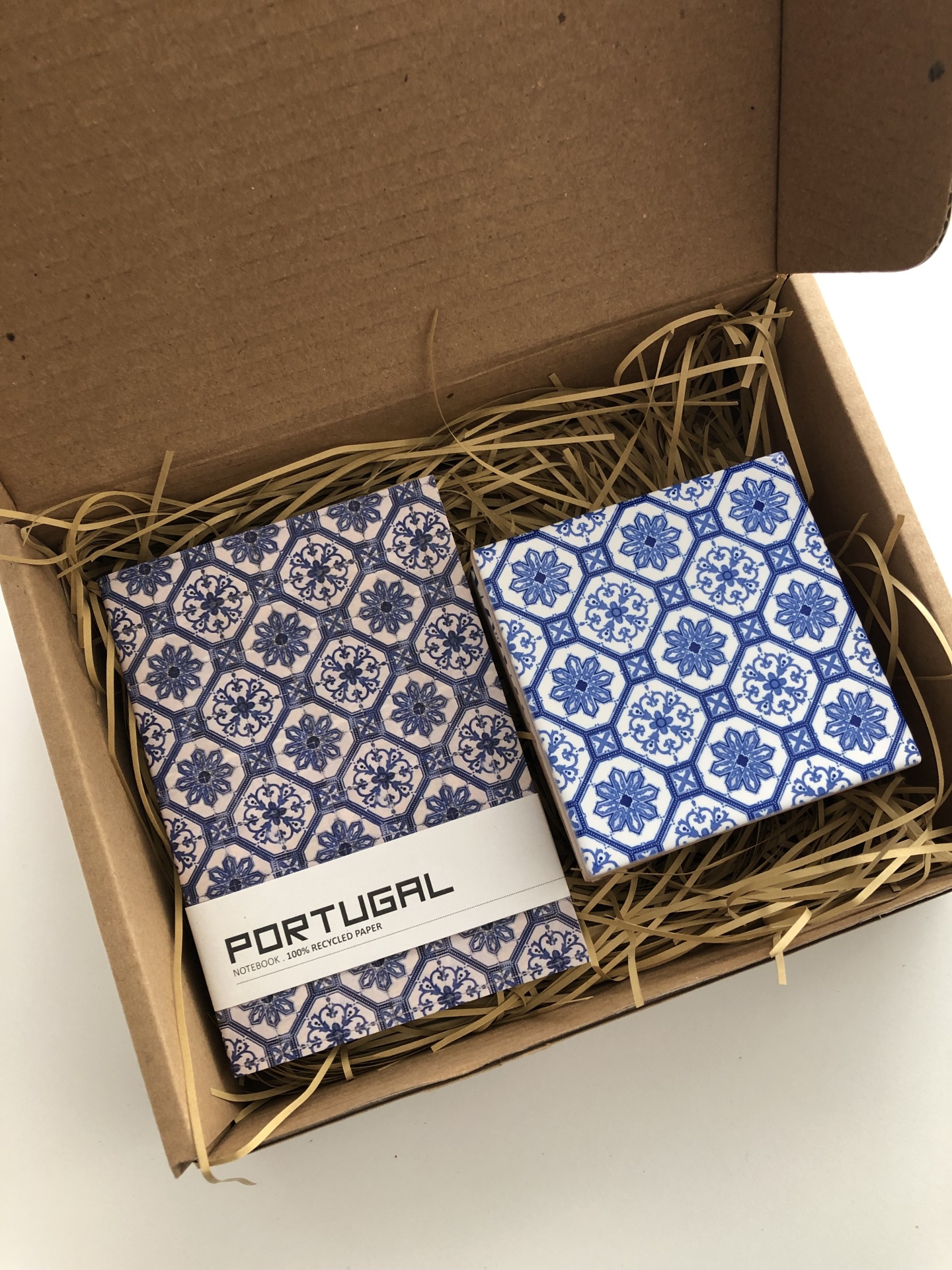 Gift box with a patterned notebook and a blue and white floral square box inside