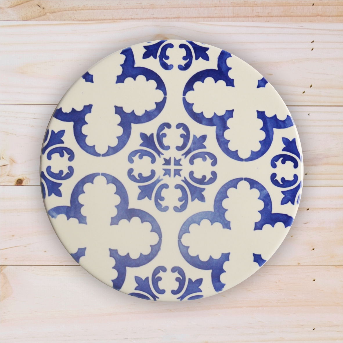Round ceramic plate with blue and white pattern on wooden surface
