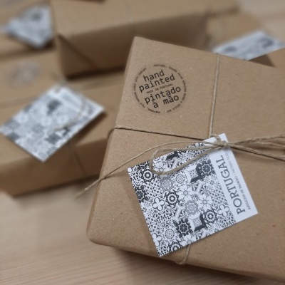Brown kraft paper packages with Portuguese tile pattern tags and hand painted stickers