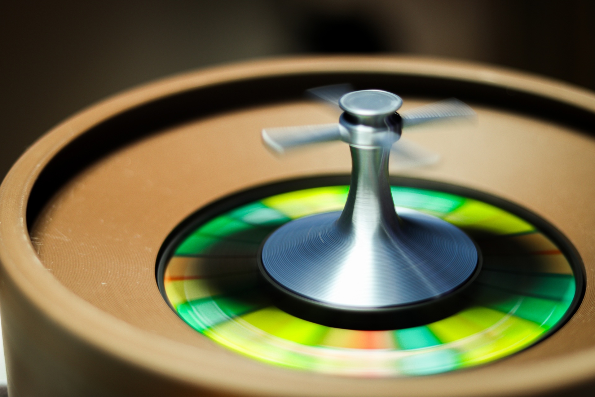 Crazy Roulette Spinning roulette wheel with metallic spindle and colorful wheel in brown frame