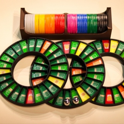 Interlocking circular game trays with colored beer mug segments and multicolored chips in a holder