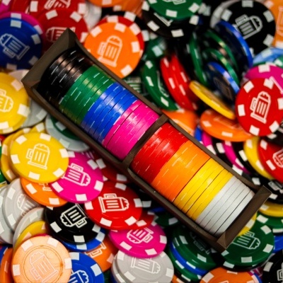 Colorful poker chips with beer mug icons, some stacked and others loose.