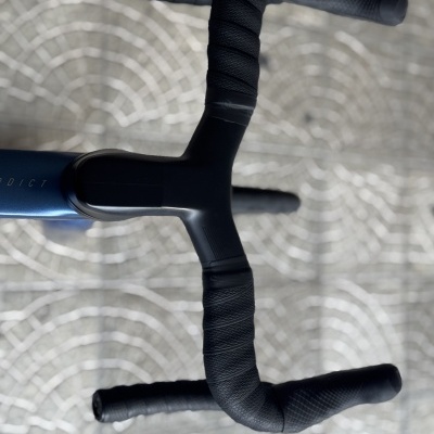 Guiador preto para bicicleta com fita texturada e quadro azul com texto PREDICT.