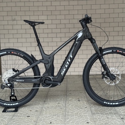 Bicicleta elétrica de montanha Scott preta com suspensão e pneus de montanha