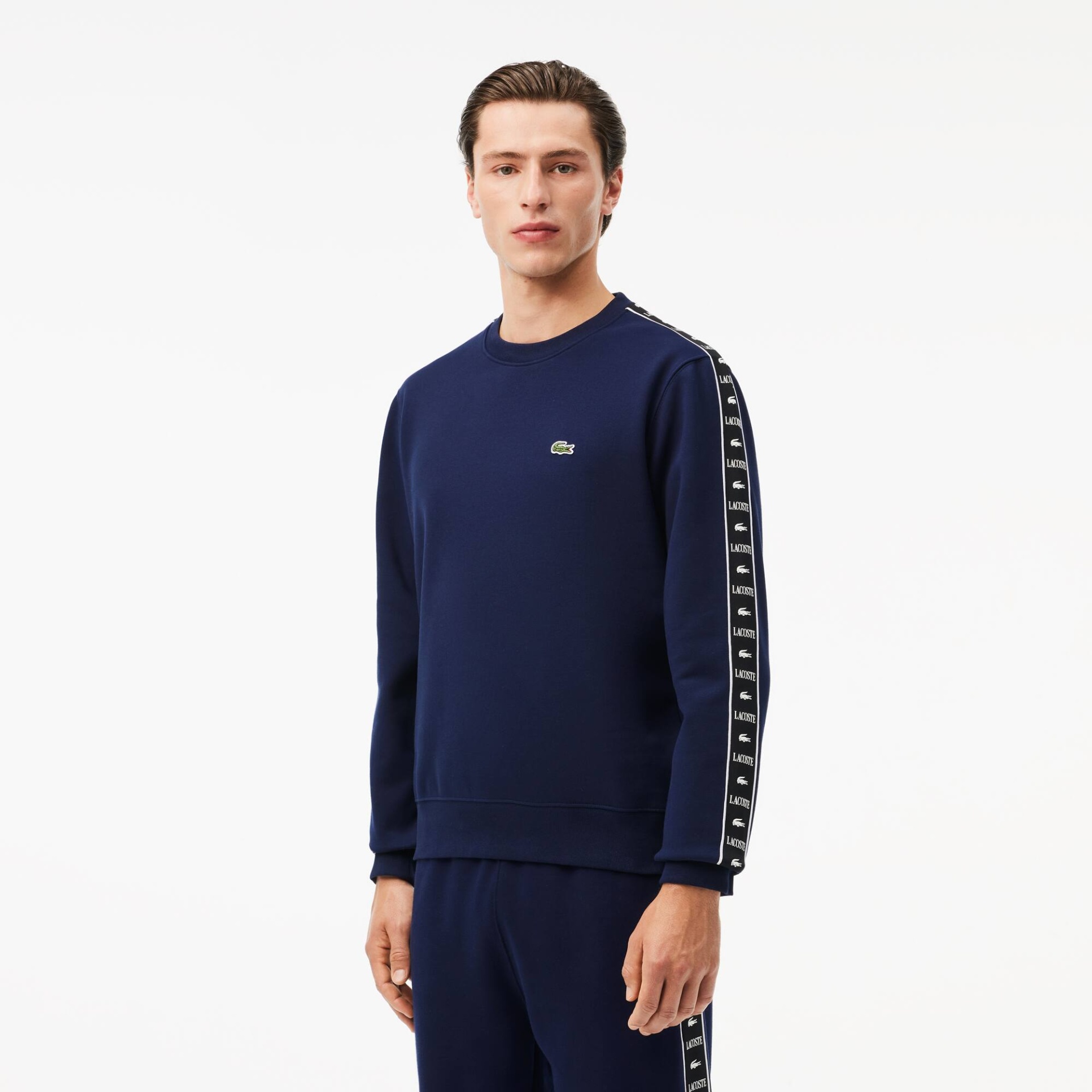 Camisola azul escura com logótipo Lacoste e faixas pretas nas mangas