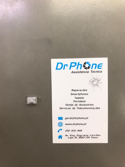 Cartão de visita da Dr Phone com componente eletrónico transparente numa superfície cinzenta