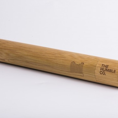 Tubo cilíndrico de bambu claro com gravação da marca THE HUMBLE CO.