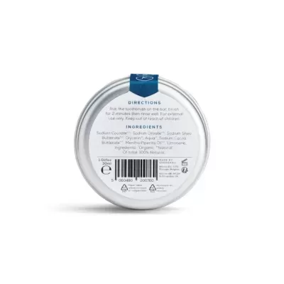 Frasco redondo metálico com rótulo branco e texto em inglês