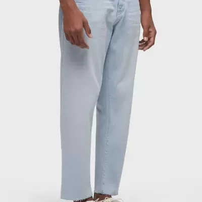 Calças de ganga azul claro com corte reto e ténis brancos