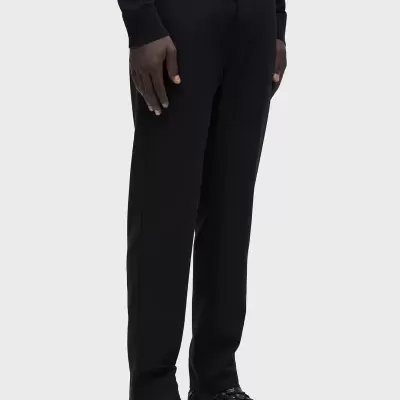 Pessoa usando calças pretas lisas e ténis pretos modernos