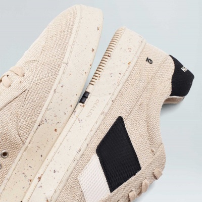 Ténis bege com solas manchadas e detalhes em preto e branco