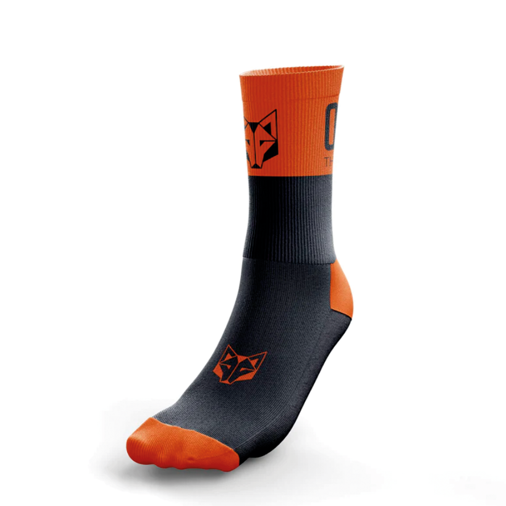 Meia desportiva preta e laranja com padrão de raposa e texto ORBEA