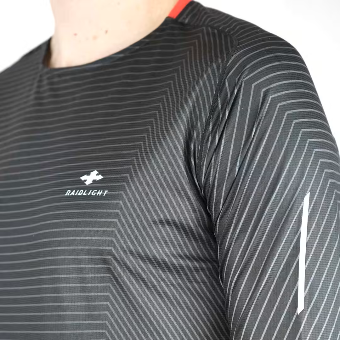 Camisola preta de desporto com padrão de linhas cinzentas e logo RAIDLIGHT.