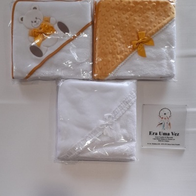 Três toalhas de bebé embaladas sobre fundo branco