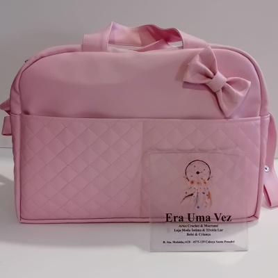 Mala rosa acolchoada para bebé com laço e placa informativa