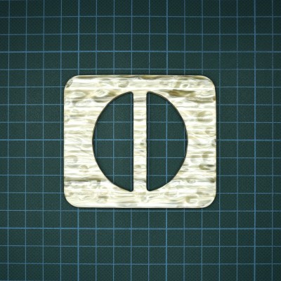 Peça quadrada marmoreada com recortes circulares sobre superfície quadriculada.